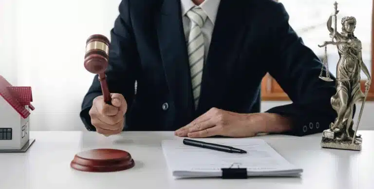 lawyer or judge holding hammer prepares to judge the case with justice and litigation scales of