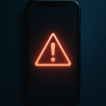 Stylized smartphone displaying a red warning symbol, symbolizing the dangers of AI-generated deepfakes and digital harassment among students.