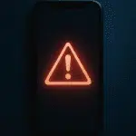 Stylized smartphone displaying a red warning symbol, symbolizing the dangers of AI-generated deepfakes and digital harassment among students.